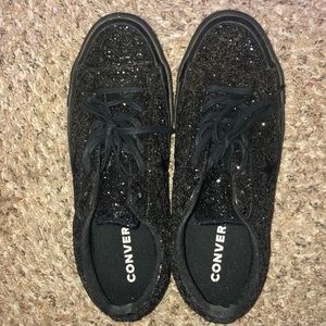 All black glitter converse shoes.